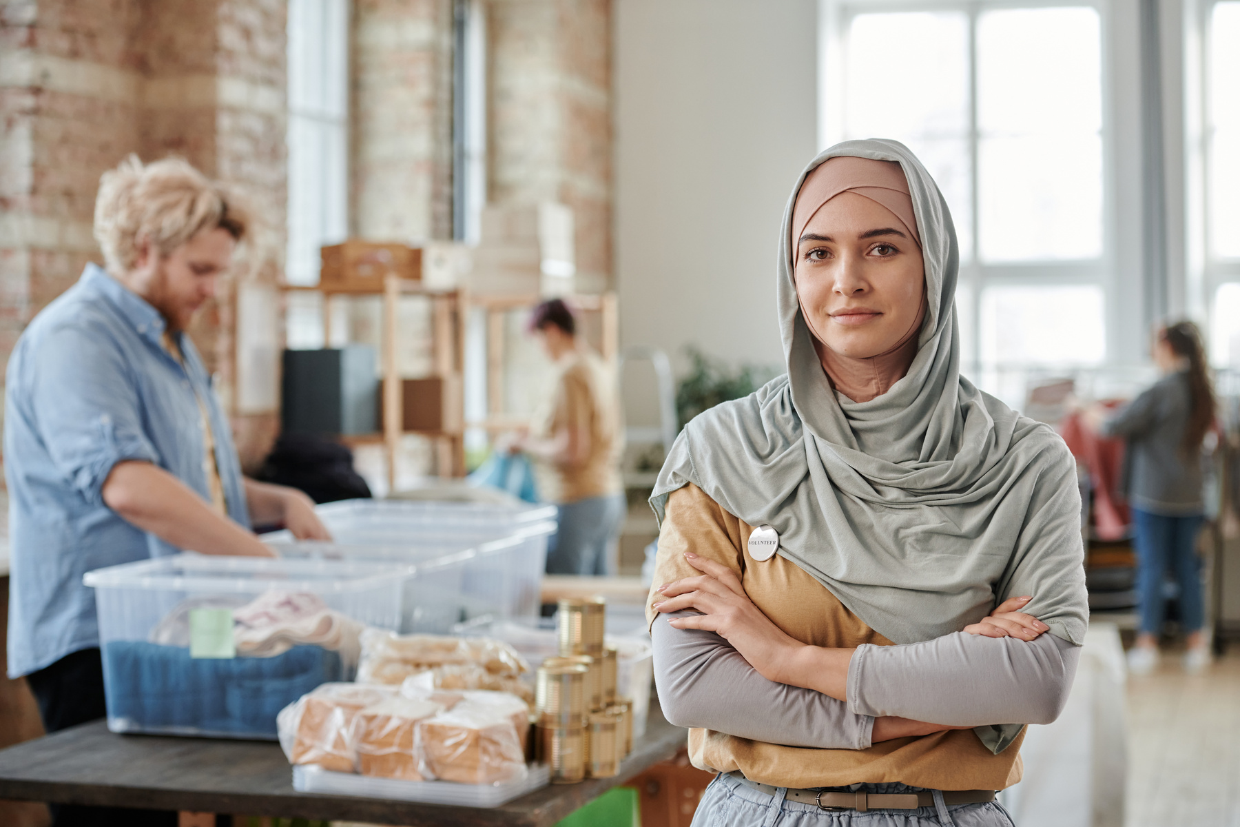 Selective Focus Photo of a Woman in a Hijab Posing with Her Arms Crossed